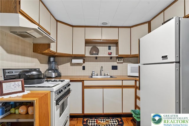 56 Hearthstone Dr, Exeter Twp, PA 19606 - kitchen featuring white appliances, open shelves, under cabinet range hood, light countertops, and backsplash