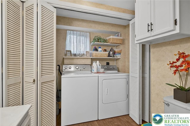 56 Hearthstone Dr, Exeter Twp, PA 19606 - laundry area with cabinet space, washing machine and clothes dryer, and wood finished floors
