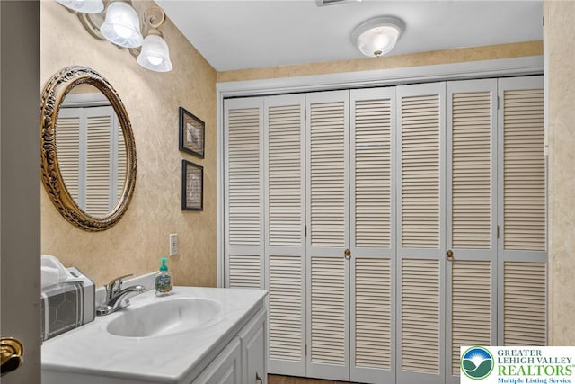 56 Hearthstone Dr, Exeter Twp, PA 19606 - bathroom with a closet, vanity, and a textured wall