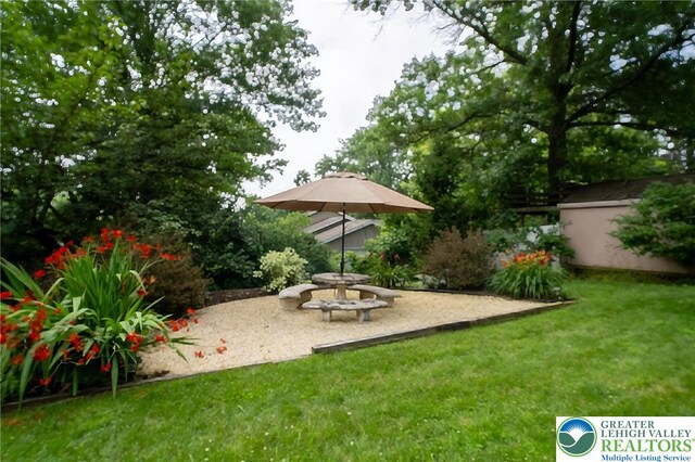 56 Hearthstone Dr, Exeter Twp, PA 19606 - view of grassy yard featuring a patio area and a storage shed