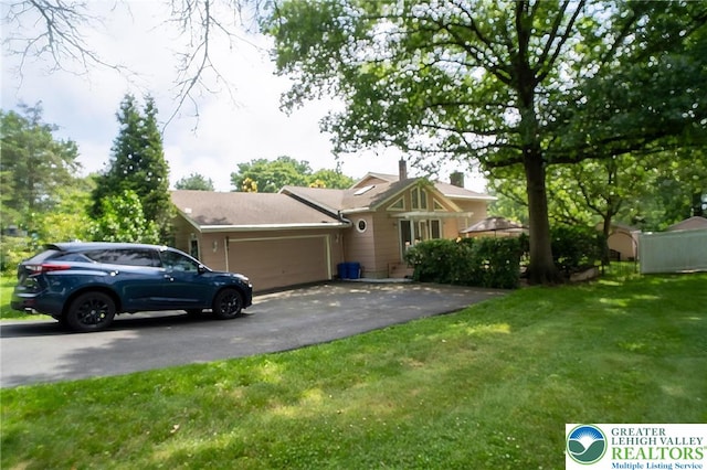 56 Hearthstone Dr, Exeter Twp, PA 19606 - view of front facade with an attached garage, asphalt driveway, and a front yard