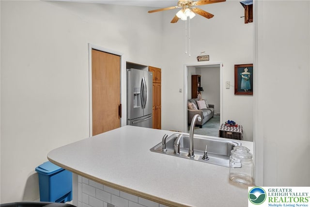 56 Hearthstone Dr, Exeter Twp, PA 19606 - kitchen featuring stainless steel refrigerator with ice dispenser, ceiling fan, brown cabinets, a high ceiling, and light countertops