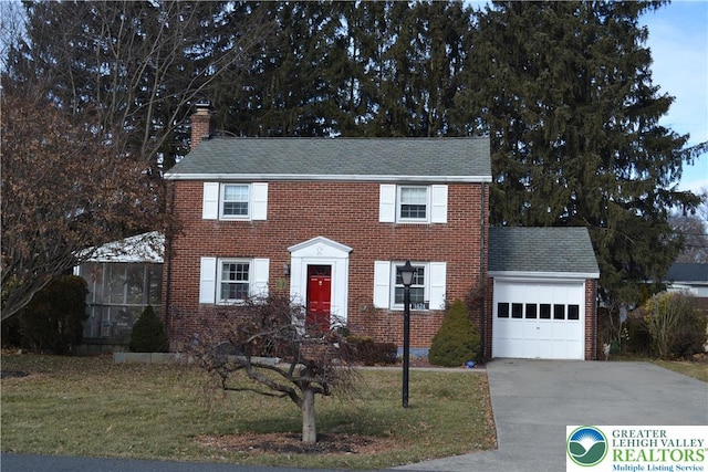 1424 Westgate Dr, Hanover Twp, PA 18017 - colonial-style house with a garage, concrete driveway, brick siding, a chimney, and a front yard