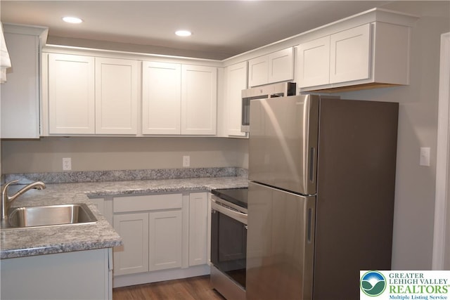 1424 Westgate Dr, Hanover Twp, PA 18017 - kitchen with appliances with stainless steel finishes, light countertops, white cabinetry, dark wood-style flooring, and recessed lighting