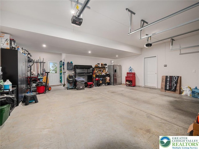 317 Fairview Ave, Wind Gap Boro, PA 18091 - garage with stainless steel fridge with ice dispenser and a garage door opener