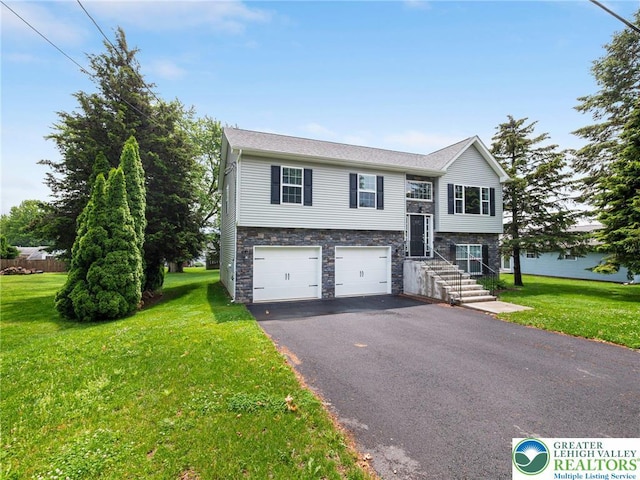 317 Fairview Ave, Wind Gap Boro, PA 18091 - split foyer home with driveway, stone siding, an attached garage, and a front yard