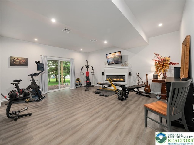 317 Fairview Ave, Wind Gap Boro, PA 18091 - exercise area with a glass covered fireplace, light wood-type flooring, and recessed lighting