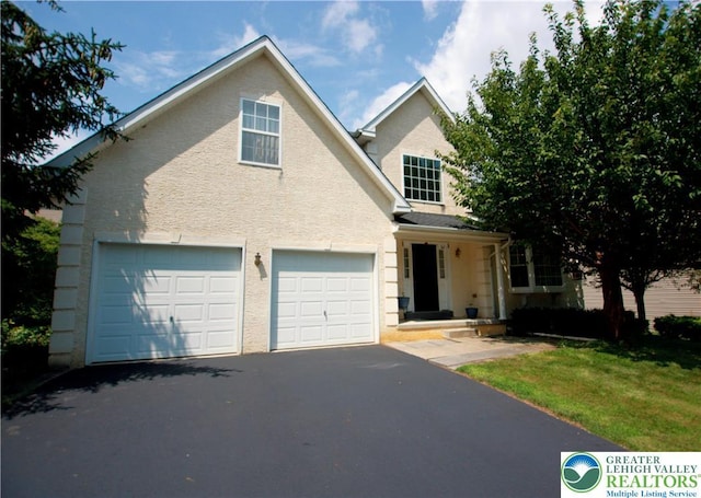 3814 Clay Dr, Lower Macungie Twp, PA 18062 - traditional home with asphalt driveway, a garage, and a front lawn