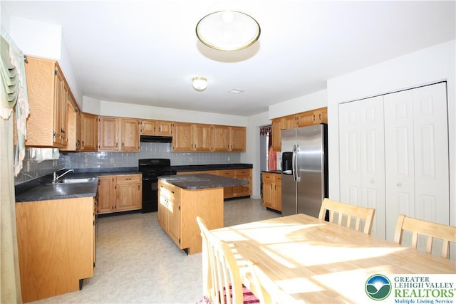 3814 Clay Dr, Lower Macungie Twp, PA 18062 - kitchen with stainless steel refrigerator with ice dispenser, a center island, dark countertops, black range with gas stovetop, and backsplash