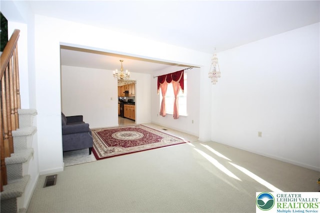 3814 Clay Dr, Lower Macungie Twp, PA 18062 - unfurnished living room with light colored carpet, a chandelier, and stairway