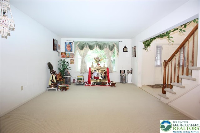 3814 Clay Dr, Lower Macungie Twp, PA 18062 - living area featuring carpet flooring, stairway, and a chandelier