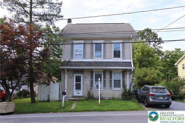 1533 E Emmaus, Salisbury Twp, PA 18103 - view of front of house featuring a front yard, brick siding, and roof with shingles