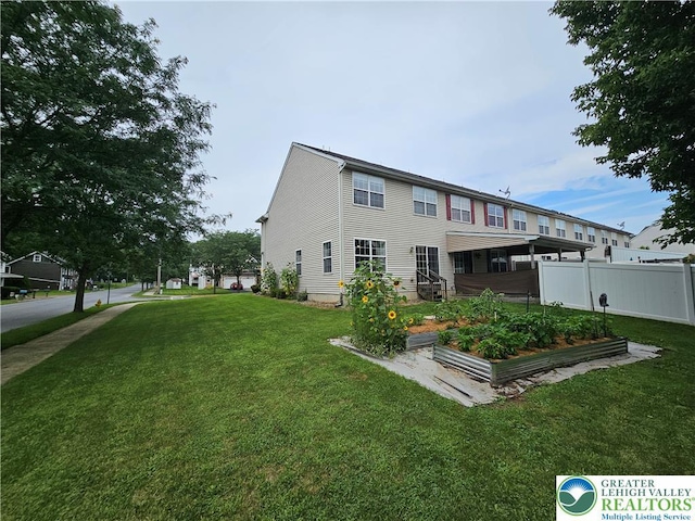 312 Maple Ct, Alburtis Boro, PA 18011 - rear view of property featuring a vegetable garden
