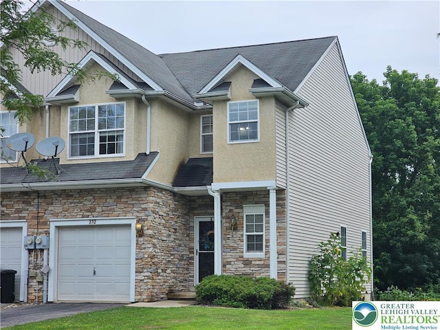 312 Maple Ct, Alburtis Boro, PA 18011 - view of front facade with stone siding, stucco siding, an attached garage, and driveway