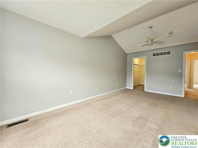 312 Maple Ct, Alburtis Boro, PA 18011 - unfurnished bedroom with carpet, vaulted ceiling, a spacious closet, and a ceiling fan