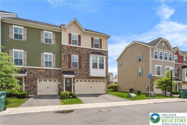 2324 Raya Way, Easton, PA 18045 - craftsman-style house with stone siding, an attached garage, driveway, and board and batten siding