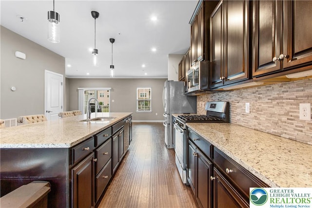 2324 Raya Way, Easton, PA 18045 - kitchen featuring appliances with stainless steel finishes, decorative backsplash, light stone countertops, dark wood-type flooring, and recessed lighting