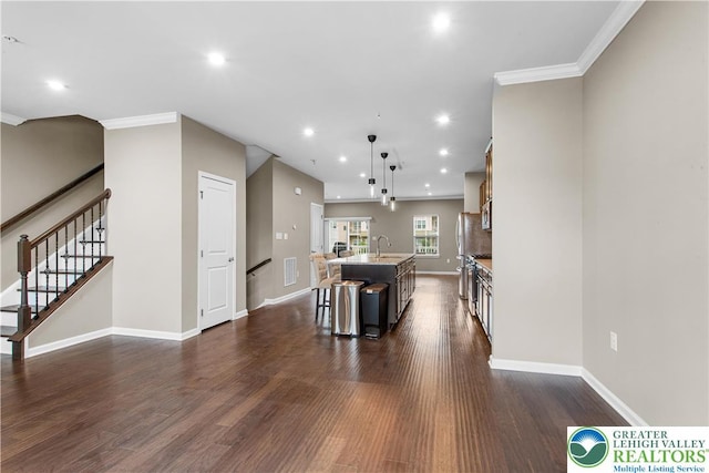 2324 Raya Way, Easton, PA 18045 - kitchen with a center island with sink, dark wood-type flooring, ornamental molding, pendant lighting, and recessed lighting