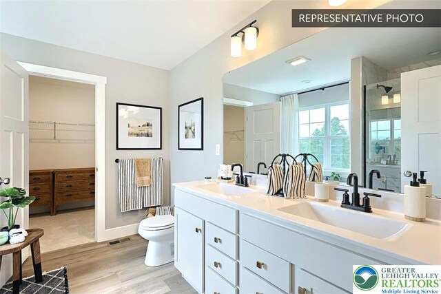 Bambi Ln Lot 40, Mahoning Twp, PA 18235 - full bath featuring double vanity, a shower stall, wood finished floors, and a walk in closet