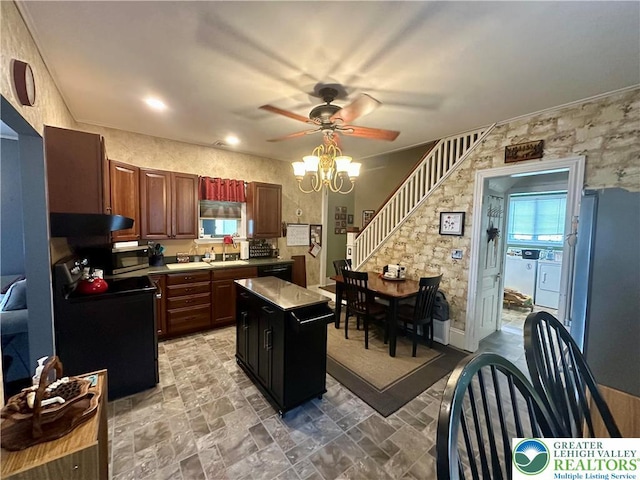 218 3rd, Lehighton Boro, PA 18235 - kitchen with washing machine and dryer, black appliances, a ceiling fan, a center island, and light countertops