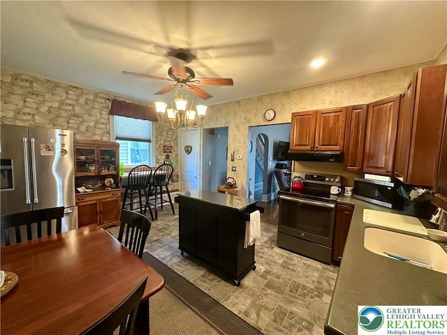 218 3rd, Lehighton Boro, PA 18235 - kitchen with stainless steel appliances, a ceiling fan, brown cabinetry, under cabinet range hood, and a chandelier