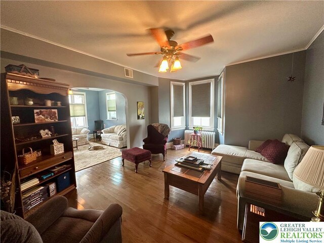 218 3rd, Lehighton Boro, PA 18235 - living area with arched walkways, ceiling fan, radiator heating unit, wood finished floors, and healthy amount of natural light