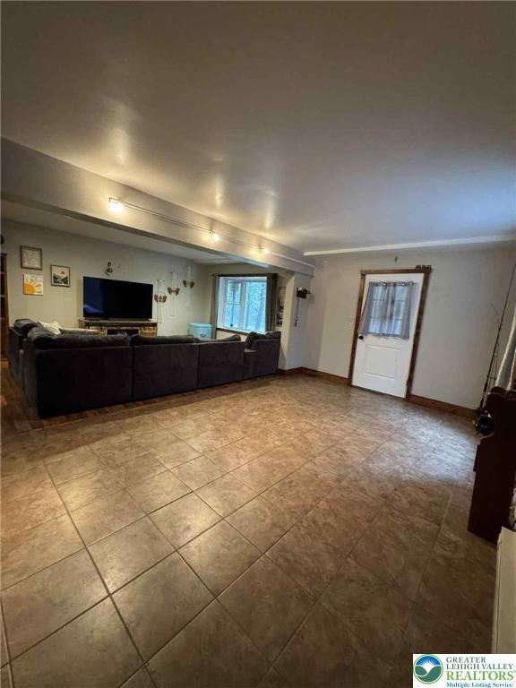 15 Hiawatha Trl, Penn Forest Twp, PA 18210 - unfurnished living room featuring tile patterned floors and baseboards