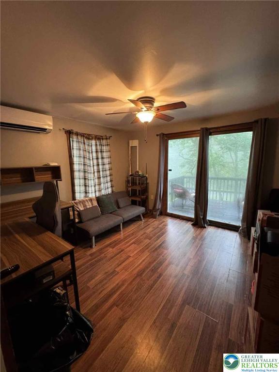 15 Hiawatha Trl, Penn Forest Twp, PA 18210 - living area with ceiling fan, wood finished floors, and a wall mounted AC