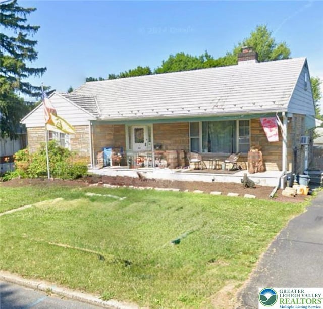 507 Dalton St, Emmaus Boro, PA 18049 - view of front facade featuring a porch, a front lawn, a chimney, and stone siding