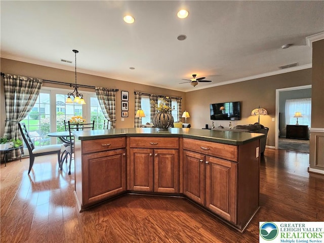 15 Devonshire Dr, Palmer Twp, PA 18045 - kitchen with dark countertops, dark wood-style flooring, ceiling fan, crown molding, and brown cabinetry