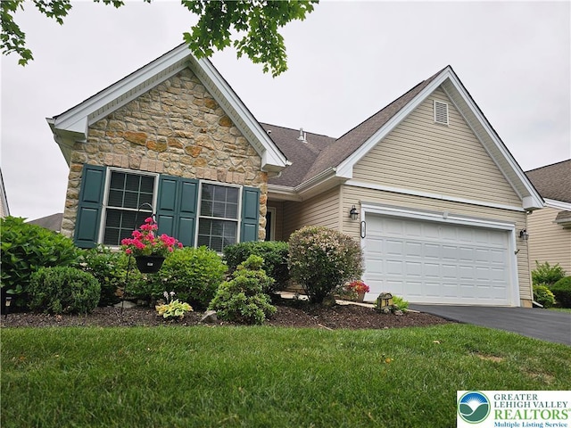 15 Devonshire Dr, Palmer Twp, PA 18045 - view of front of house featuring driveway, a garage, and a front yard