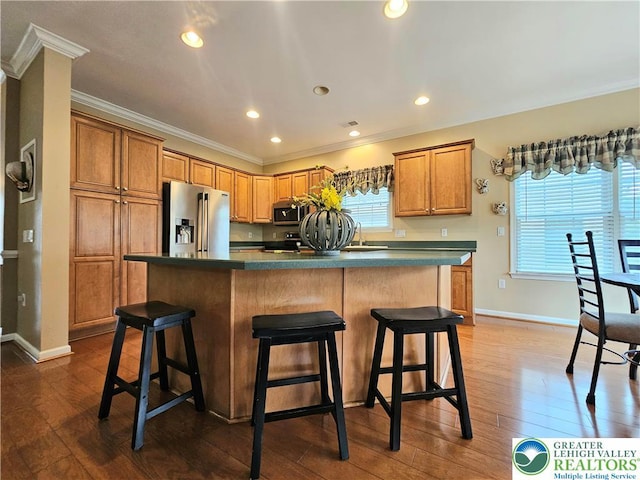 15 Devonshire Dr, Palmer Twp, PA 18045 - kitchen with crown molding, appliances with stainless steel finishes, a breakfast bar, dark wood-style flooring, and dark countertops