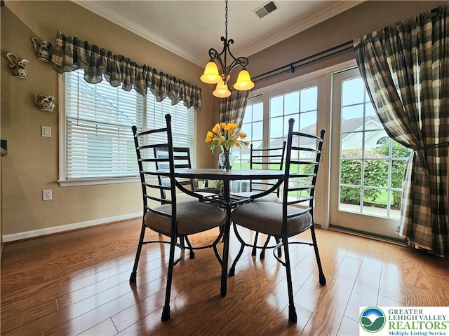 15 Devonshire Dr, Palmer Twp, PA 18045 - dining area with crown molding, a chandelier, healthy amount of natural light, and light wood-style flooring