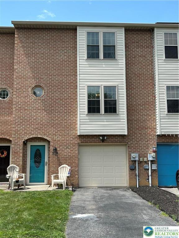359 2nd, Alburtis Boro, PA 18011 - view of front of house with an attached garage, driveway, and brick siding