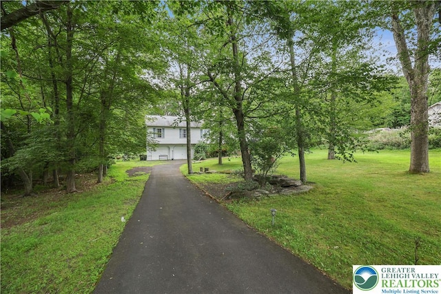 303 Lakefield Ter, Jackson Twp, PA 18360 - view of front of house featuring asphalt driveway, a garage, and a front yard