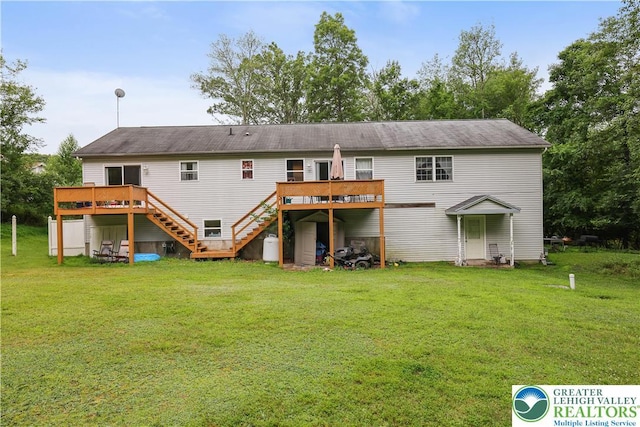 303 Lakefield Ter, Jackson Twp, PA 18360 - rear view of property featuring stairway, a deck, and a lawn