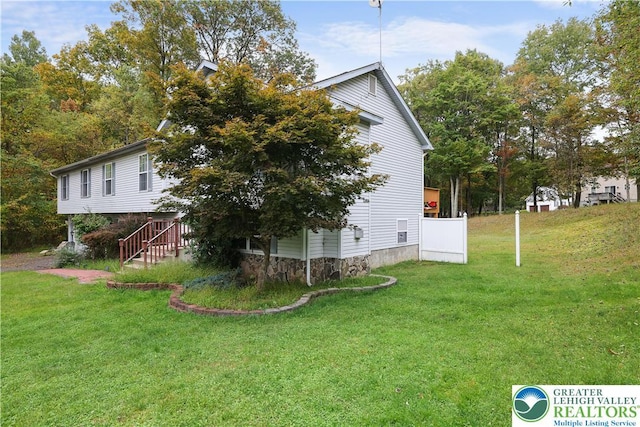 303 Lakefield Ter, Jackson Twp, PA 18360 - view of home's exterior with a lawn