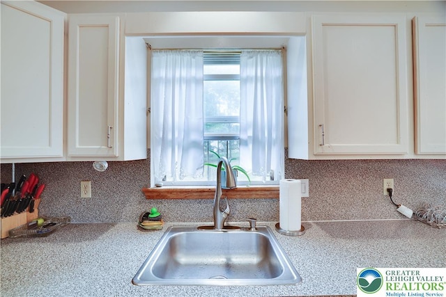 303 Lakefield Ter, Jackson Twp, PA 18360 - kitchen with light countertops, white cabinets, and tasteful backsplash