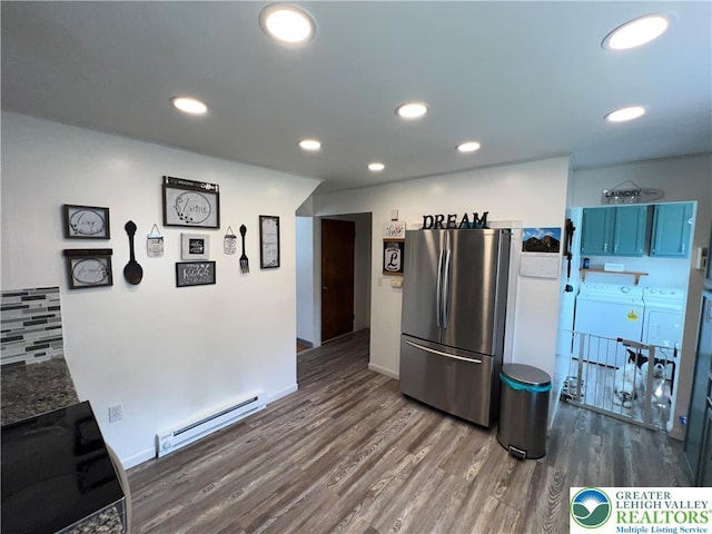 532 6th St, Whitehall Twp, PA 18052 - kitchen featuring independent washer and dryer, freestanding refrigerator, a baseboard heating unit, electric range oven, and dark wood-type flooring