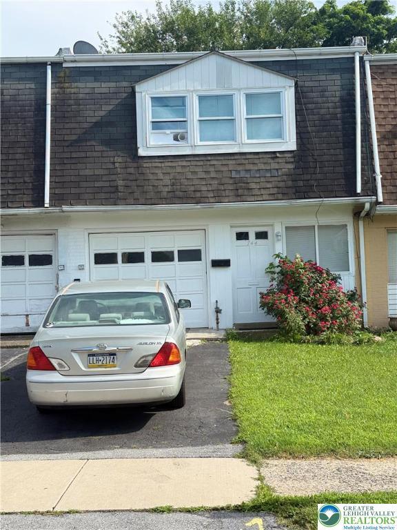 744 E Green St, Allentown City, PA 18109 - view of side of property with mansard roof, a shingled roof, a garage, and a lawn