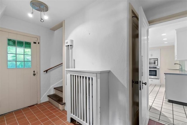 interior space with sink and light tile floors