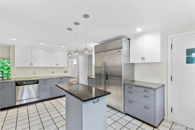 kitchen featuring pendant lighting, stainless steel appliances, light tile floors, gray cabinets, and white cabinets