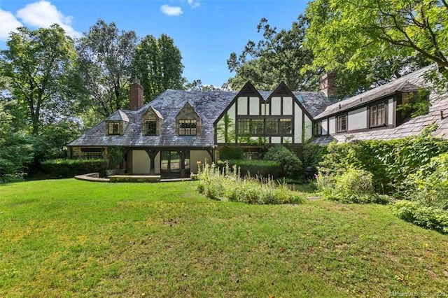 rear view of house with a yard