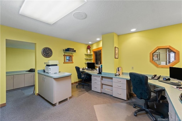 office area featuring a textured ceiling and light carpet