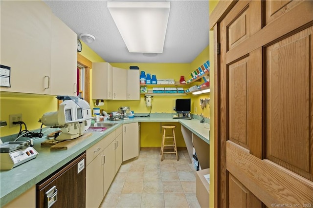 kitchen with sink and light tile flooring