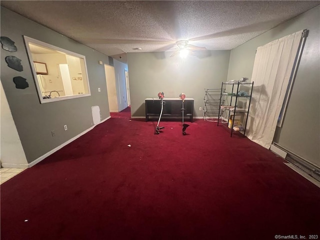 playroom with ceiling fan, carpet flooring, and a textured ceiling