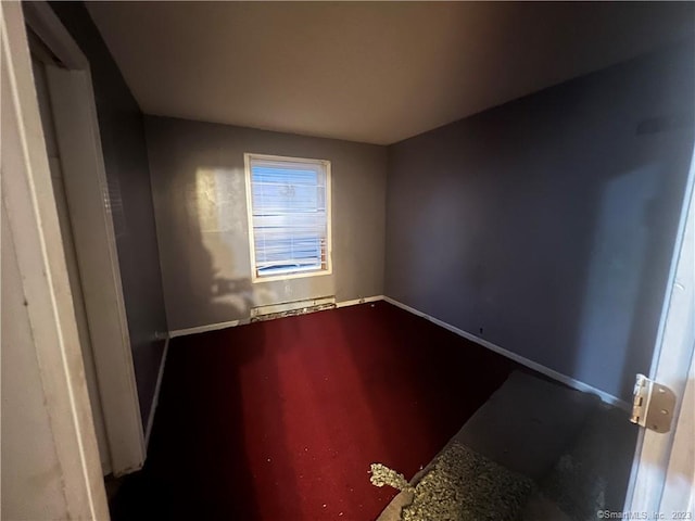 unfurnished room featuring a baseboard radiator