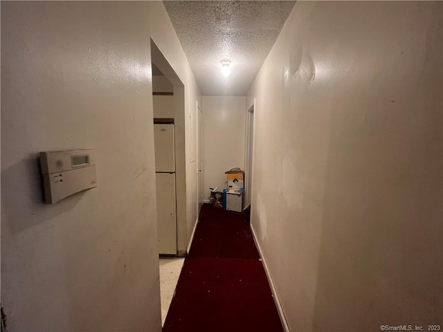 corridor featuring a textured ceiling