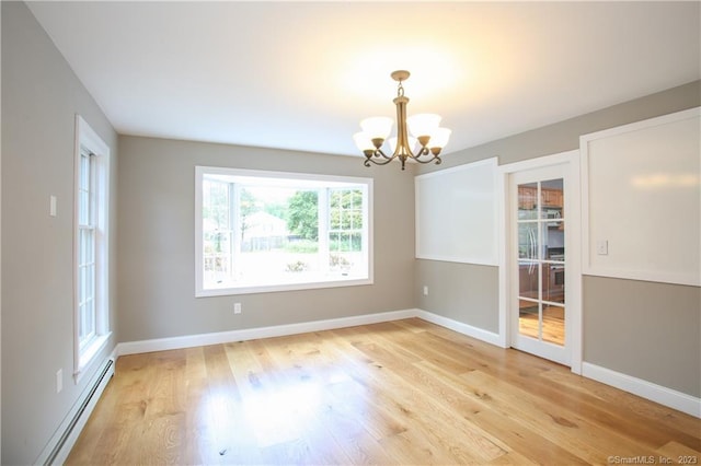277 Ashley Falls Rd, North Canaan, CT 06018 - unfurnished room with light hardwood / wood-style floors, a notable chandelier, and a baseboard radiator
