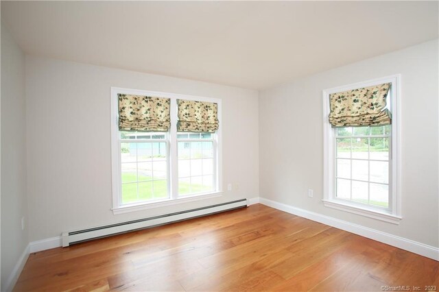 277 Ashley Falls Rd, North Canaan, CT 06018 - empty room with a healthy amount of sunlight, light wood-type flooring, and baseboard heating